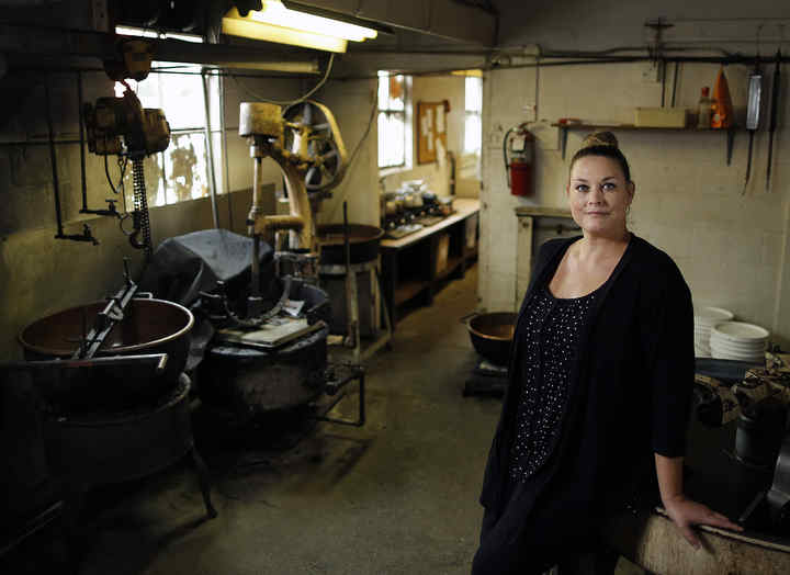 Dee Dee Eagle of Eagle Candies, a fourth generation business, poses for a photo inside the shop in Clintonville.  Eagle Candies is struggling to save their building.   (Kyle Robertson / The Columbus Dispatch)